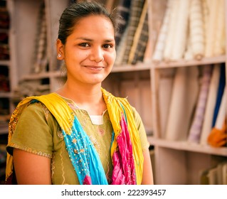 UDAIPUR, RAJASTAN -INDIA : MAY 27 2013 - Unidentified girl, outside a fabric store posing and smiling on May 27, 2013 in Udaipur, India.