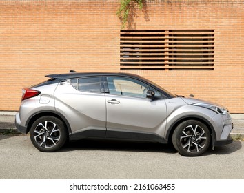 Udine, Italy. May 25, 2022. Silver Gray Honda CR V Hybrid Parked At The Roadside. Side View With Brick Wall On Background.	