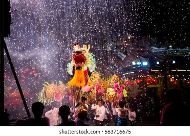 UDONTHANI THAILAND, January 2017 :Dragon dance show under firework waterfall in the festival of 2017 Chinese New Year in the night at San Jao Pu Ya Udonthani ,Thailand