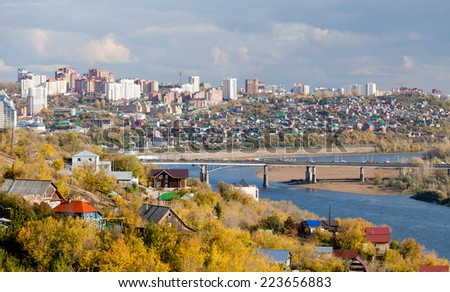 Ufa city at the autumn. You can see Belaya (White) river and modern district behind the bridge.