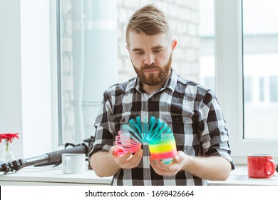 UFA, RUSSIA - April 3, 2019 : man playing with a slinky indoors
