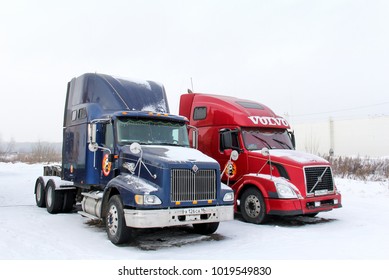 Ufa, Russia - February 3, 2018: American semi-trailer trucks International 9200i and Volvo VNL64T in the city street.
