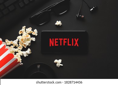 Ufa, Russia - October 7, 2020: Table with popcorn and Netflix logo. Netflix is a global provider of streaming movies and TV series.