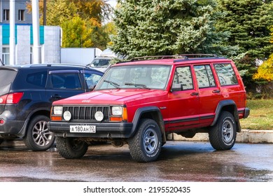 Ufa, Russia - September 18, 2021: Red Offroad Vehicle Jeep Cherokee (XJ) In The City Street.