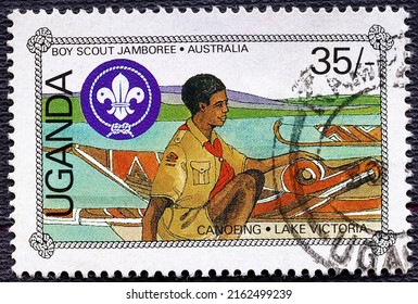 UGANDA - CIRCA 1986: Stamp Printed In Uganda Depicting Canoeing On Lake Victoria, Series 14 Boy Scout Rally In Australia.