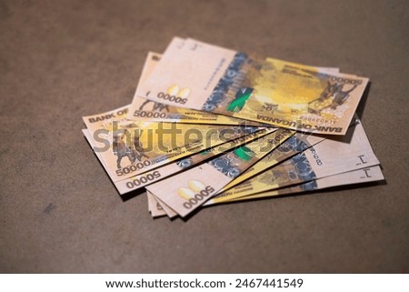 Ugandan shilling notes on table, paper currency on wooden desk background