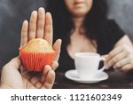 ugar addiction, healthy lifestyle, weight loss, dietary, healthcare and medical concept. Cropped portrait of overweight woman refusing muffin