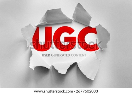 UGC (User Generated Content) concept revealed through torn paper, symbolizing authenticity, creativity, and audience engagement in digital marketing and content creation strategies