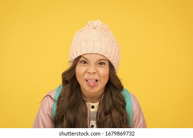 Ugh, Yuck. Little Schoolchild Stick Tongue. Little Kid Make Grimace Yellow Background. Little Girl Back To School. Little Child With Autumn Look.