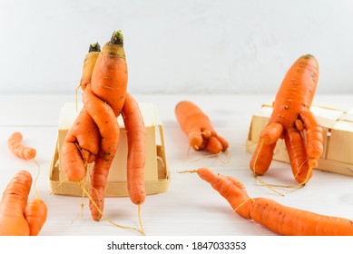 Ugly Carrot On A White Wooden Table. Ugly Vegetables Concept.