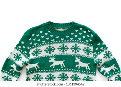 Ugly Christmas Sweater Concept. Festive Jumper With Deer And Snowflake Patterns Isolated On White. Close Up, Top View, Flat Lay, Copy Space, Background.