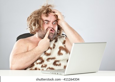 Ugly Doubtful Prehistoric Man On Laptop