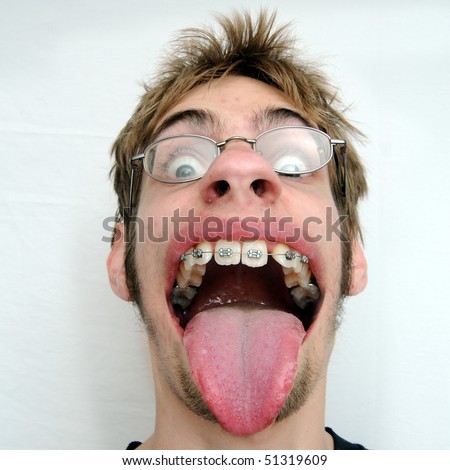 An ugly man with a huge mouth and tongue sticking out