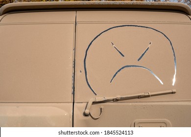 Ugly Smile On Dirty Windscreen Of Car. Muddy Vehicle, Wash Me Concept.