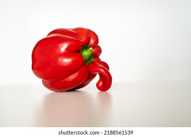 Ugly veggie red bell pepper on the whitetable with white background