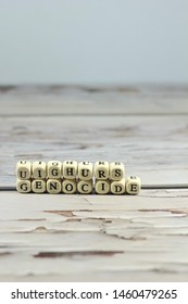 Uighur Genocide Word Make With Wooden Letter Cube On The Table.