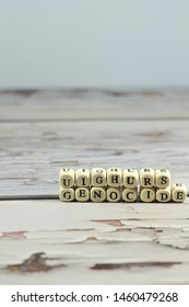 Uighur Genocide Word Make With Wooden Letter Cube On The Table.