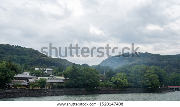 UJI, KYOTO PREFECTURE, JAPAN - JULY 18, 2019: \
The scenic greenery view of Uji-gawa River, which divides the city\
of Uji into two different areas.\
