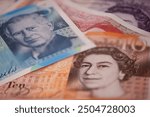 UK banknotes. British Pounds. Currency exchange concept. Money background. Selective focus. Flat lay.