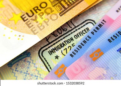 UK Biometrical Residence Permit Cards (BRP), Immigration Stamp In Passport And A Euro Banknote. The Concept Photo For Immigration Between UK - EU.