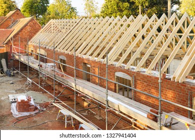 UK building site with scaffolding. Part of a period house is restored using modern building methods.