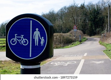 UK Circular Shared Cycling And Walking Sign On A Blue Background. Room For Text.