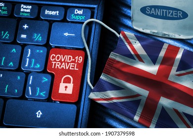 UK COVID-19 Coronavirus Travel Restrictions Concept Showing Red Button Warning On Keyboard With Flag Face Mask And Hand Sanitizer. New Normal In Global Travel.