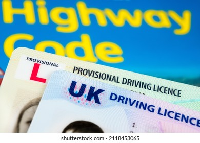 UK Driving Licence. Provisional and Full licence cards placed on Highway Code book. Stafford, United Kingdom, January 30, 2022.
