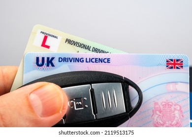 UK Driving Licence. Provisional and Full licence cards and car key on top of them. Selective focus. Concept for driving school. Stafford, United Kingdom, January 30, 2022.
