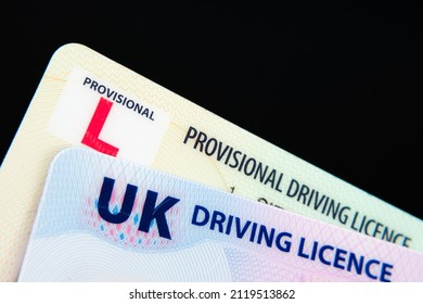 UK Driving Licence. Provisional and Full licence cards isolated on dark background. Macro. Selective focus.