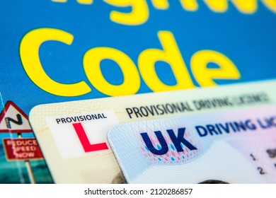 UK Driving Licence. Provisional and Full licence cards placed on Highway Code book. Macro. Stafford, United Kingdom, January 30, 2022.