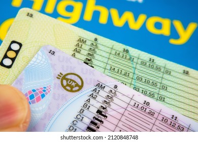 UK Driving Licence. Provisional and Full licence cards placed on Highway Code book. Macro. Stafford, United Kingdom, January 30, 2022.