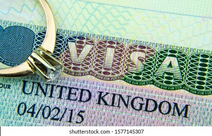 UK Entry Visa Sticker In A Passport And The Engagement Ring Placed On Top. Conceptual Photo For Fiance / Spouse Visa And Immigration In General.