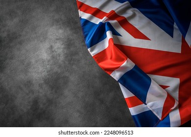 UK flag on a dark background. Great Britain flag on the background of a dark canvas for a patriotic concept and national celebrations.