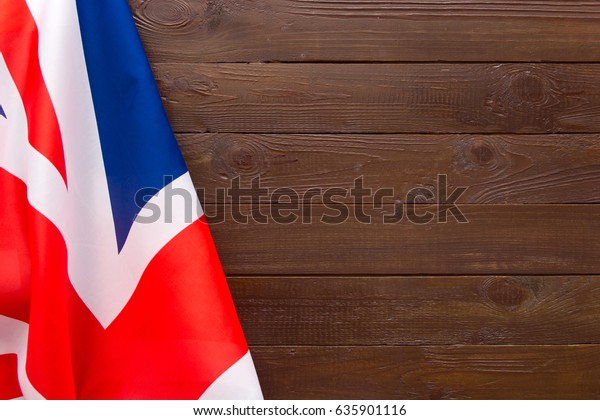 UK flag on wooden background.The place to\
advertise, template.