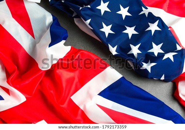 UK flag and USA Flag на stone\
background . Relations between countries .The view from the\
top.