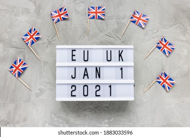 UK Flags And Text EU UK January 1 2021 On Gray Background. Brexit, Trade Deal, Transition Period, Changes And New Rules Concept. Flat Lay, Copy Space