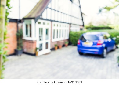 Uk House Residential Driveway, With A Blue Parked Car, Blurred.