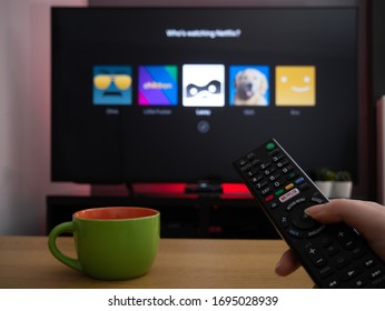 UK, March 2020: TV Television Netflix profile selection page who's watching with remote control