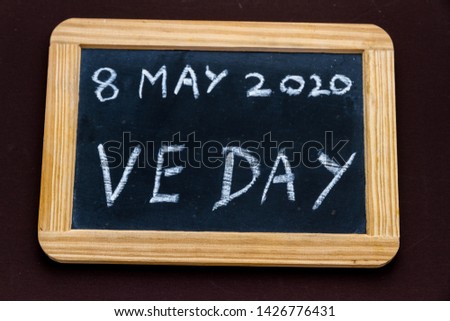 UK may bank holiday moved from 4 to 8 May 2020 to celebrate 75 years of end of WWII VE Day on old fashioned school writing slate.
