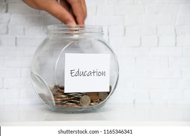 UK Money Jar On A White Shelf In A Household Living Room. Saving For Education Concept