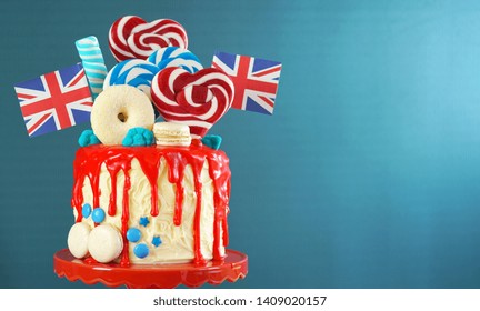 UK on-trend candyland fantasy drip cake with red, white and blue decorations, lollipops and flags with copy space. - Shutterstock ID 1409020157