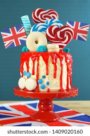 UK on-trend candyland fantasy drip cake with red, white and blue decorations, lollipops and flags. - Shutterstock ID 1409020160