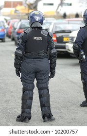 Uk Police Officer In Full Riot Gear At The Scene Of A Public Disturbance.