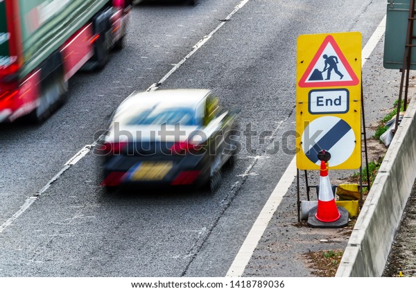 UK Road\
Services Roadworks End sign on\
motorway