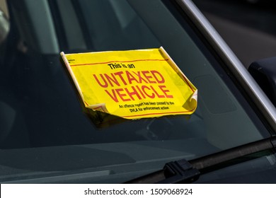 UK Untaxed Vehicle Sticker On The Windscreen Of A Parked Car