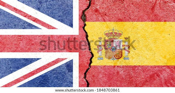 UK VS Spain national\
flags icon on broken weathered cracked concrete wall background,\
abstract international government political conflicts concept\
texture wallpaper