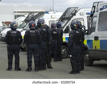 Uk Welsh Police Officers In Full Riot Gear At The Scene Of A Public Disturbance.