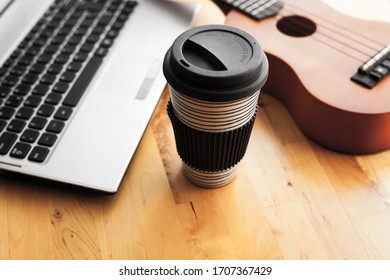 Ukelele On A Table With A Laptop And A Cap Of Coffee