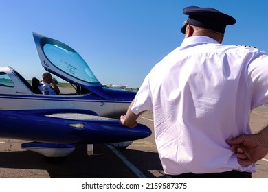 Ukraine, Cherkassy - June 26, 2018:The pilot stands near a light-engine plane leaning on the wing.